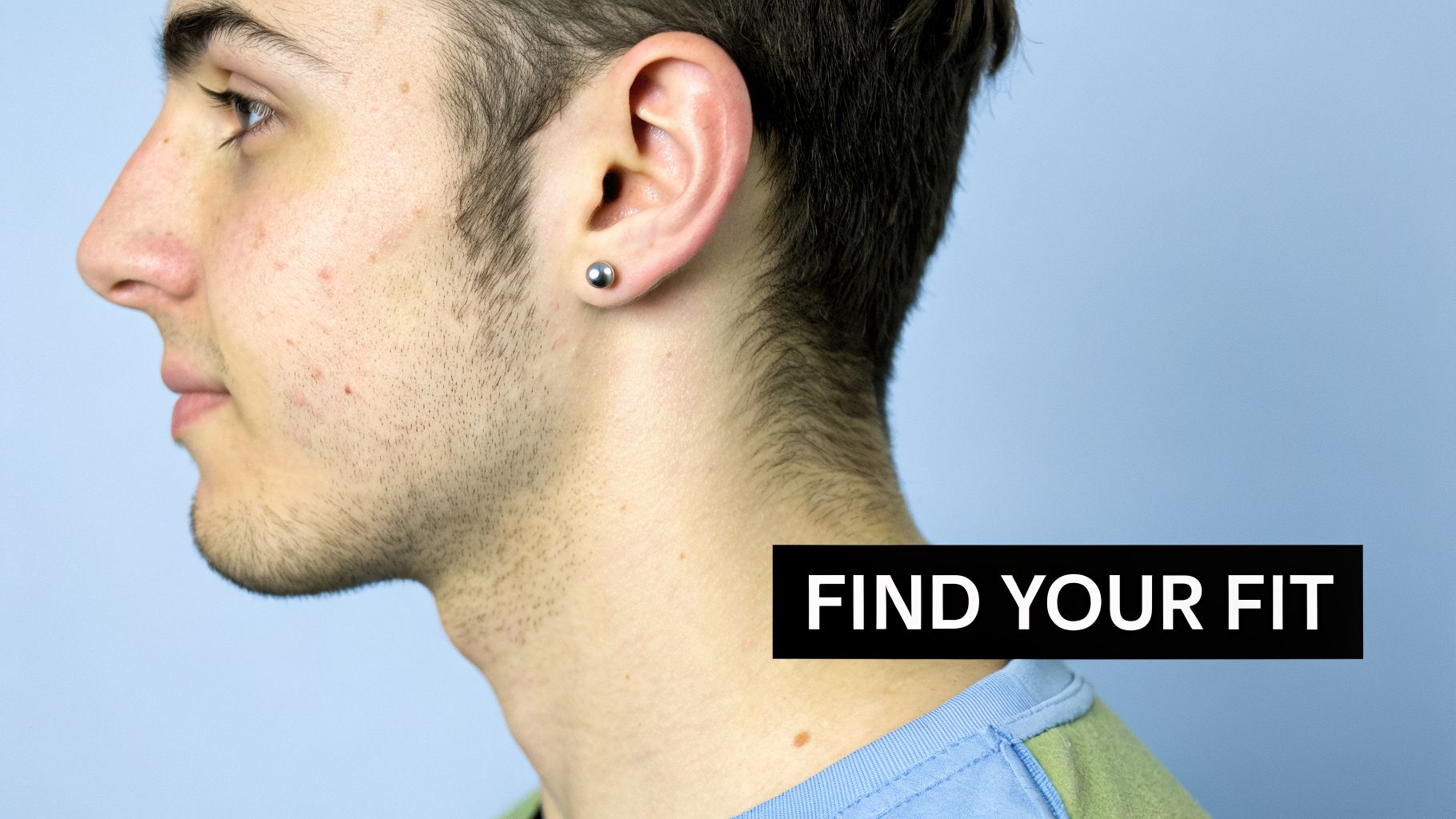 Side profile of a young man with a silver stud ear piercing and stubble, with 'FIND YOUR FIT' text overlay.