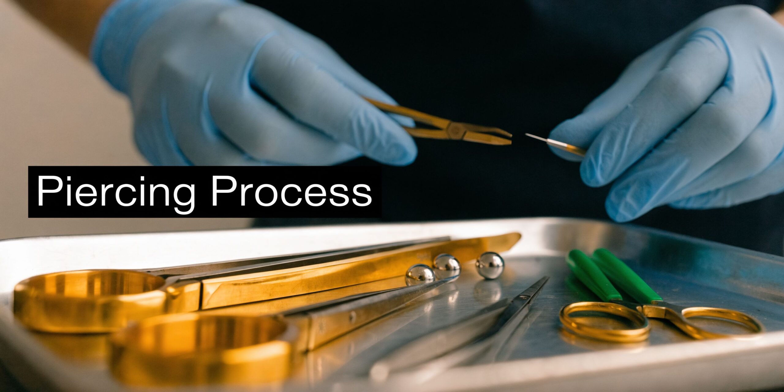 A professional piercer in blue gloves prepares sterile equipment for a piercing procedure on a metal tray.