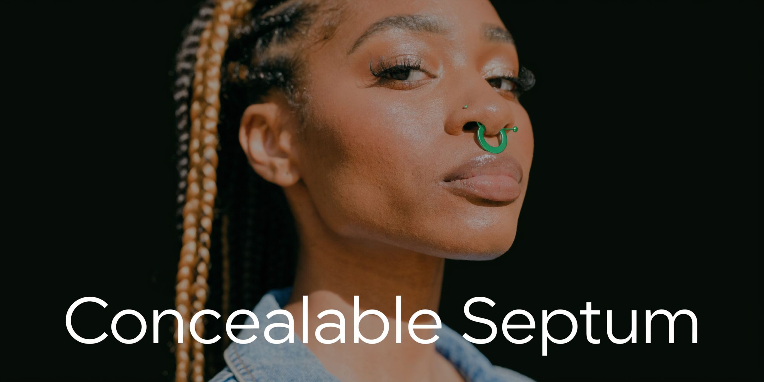 A young woman with braided hair wearing a vibrant green septum ring piercing against a black background.