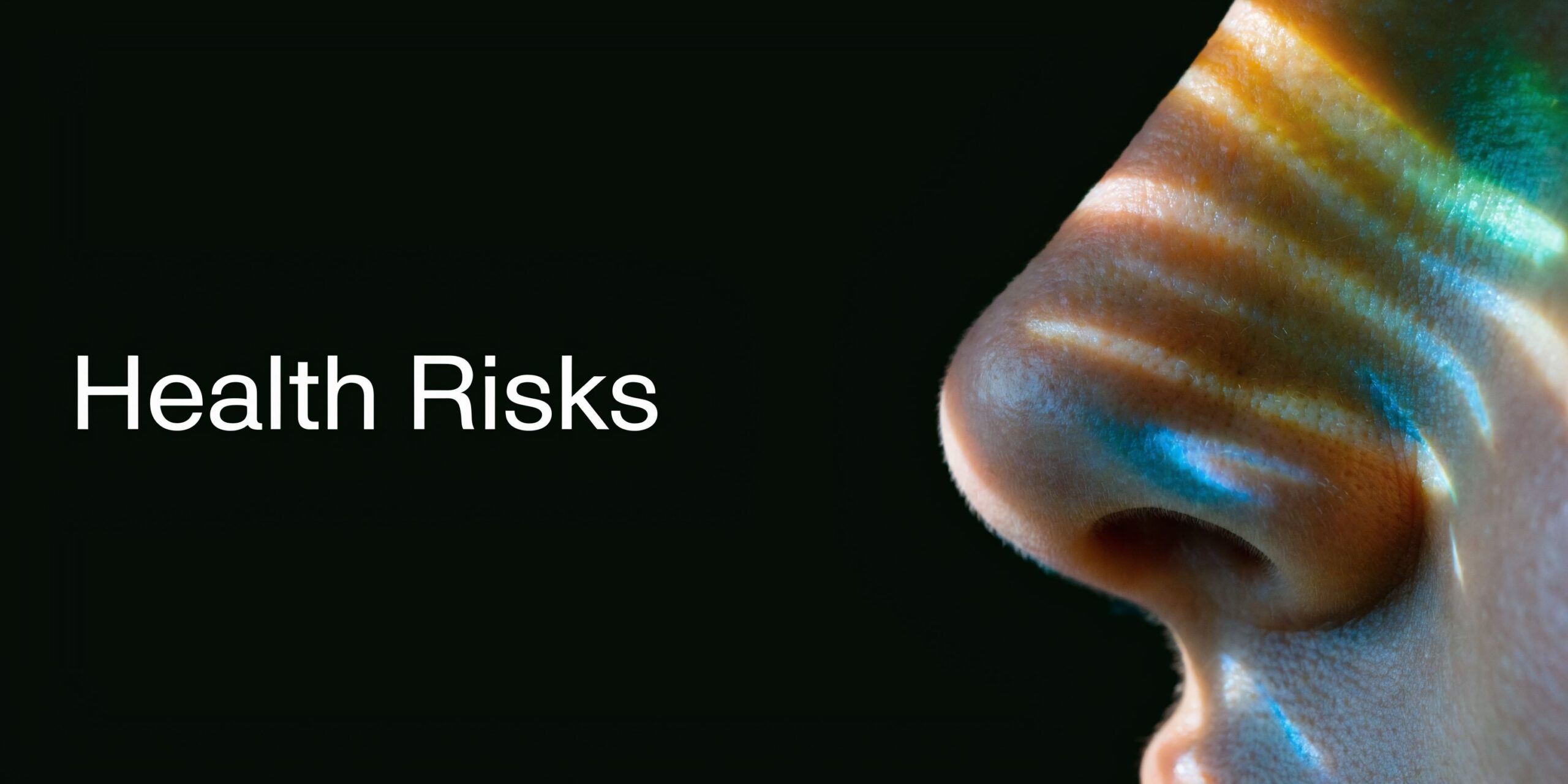 A close-up view of a human nose with light refraction patterns reflecting on the skin's surface.