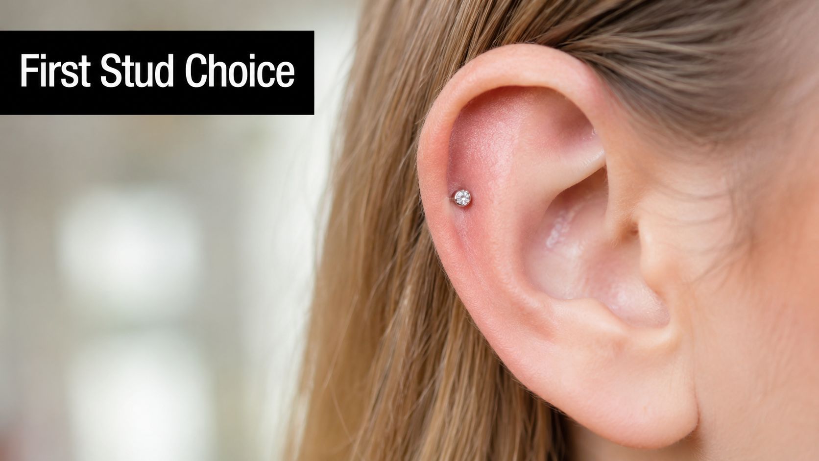 A close-up view of a woman's ear featuring a sparkling silver stud earring in a helix piercing.