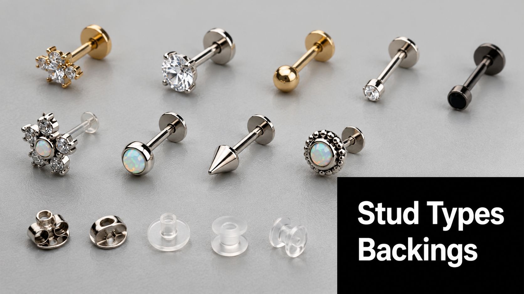 Various metal and clear earring studs and backings arranged on a light grey background for display.