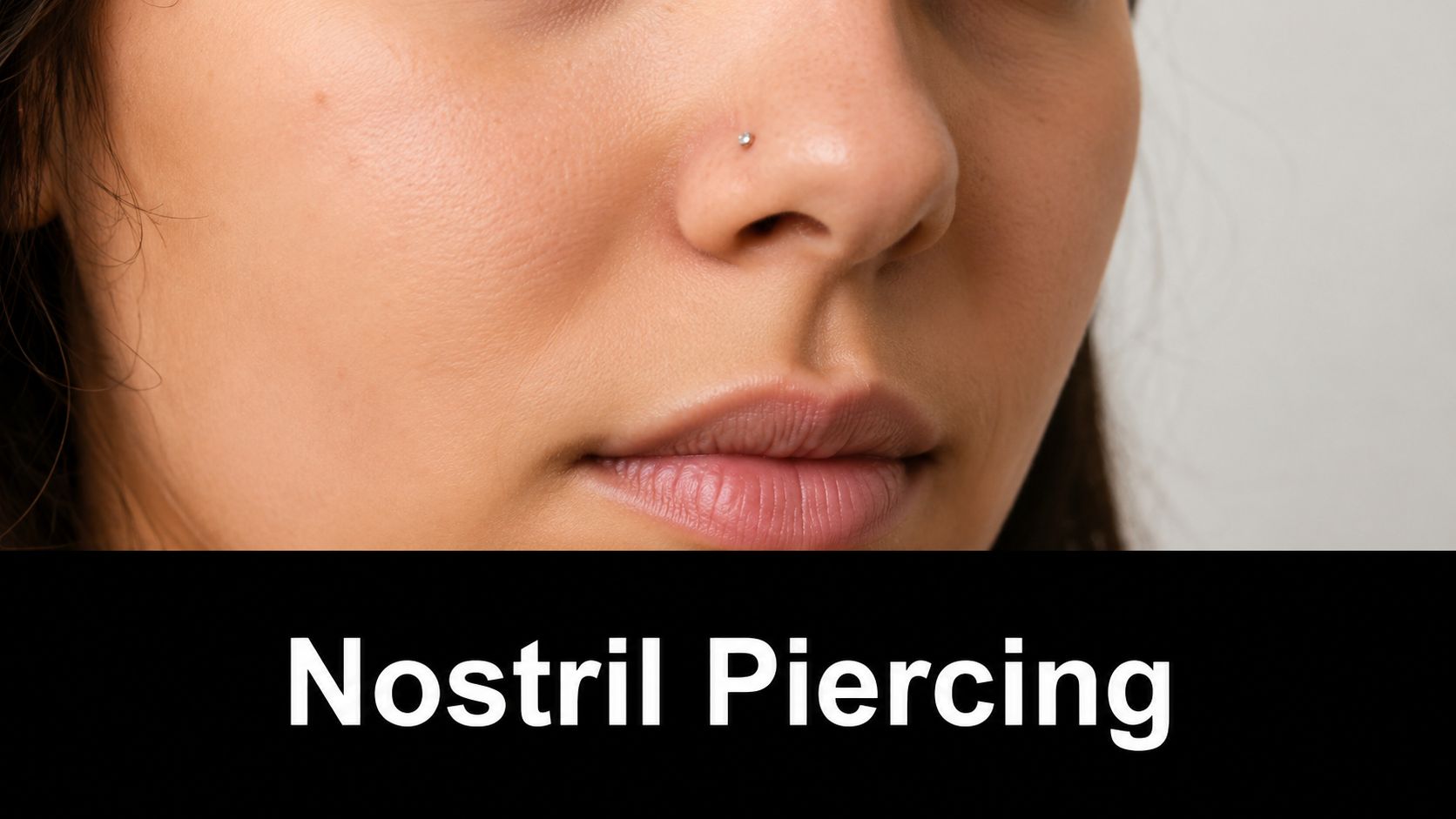Close up of a woman wearing a small, sparkling stud nose ring on her right nostril.