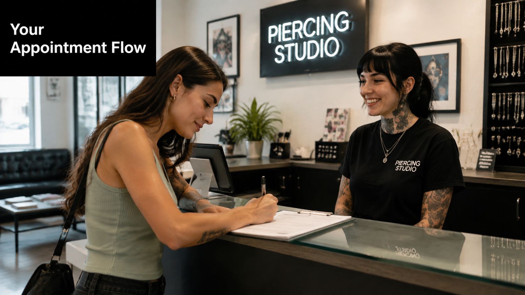 A young woman signs paperwork at the front desk of a modern piercing studio with a receptionist.