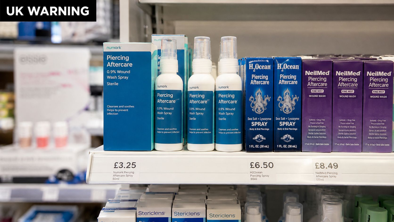 A store shelf displaying various brands of piercing aftercare spray for cleansing and soothing body piercings.