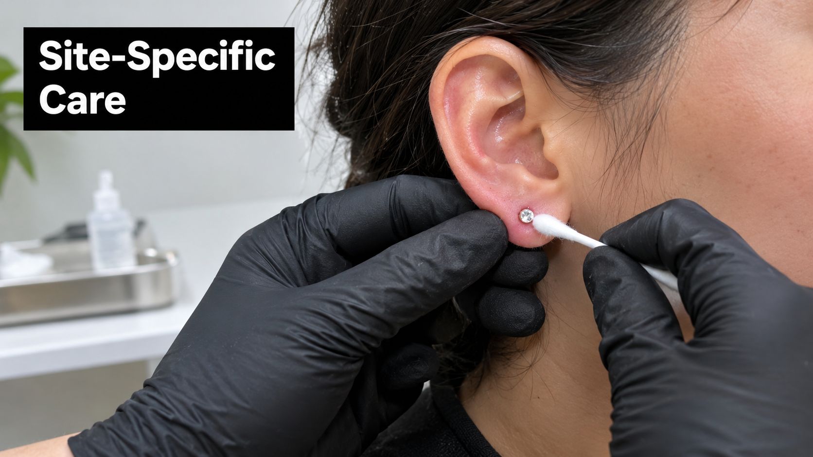 A professional with black gloves cleaning a new ear piercing with a cotton swab in a clinic.
