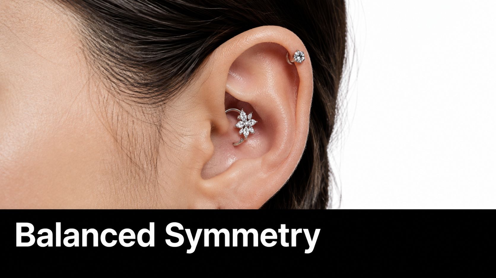 A close-up view of an ear featuring a delicate flower-shaped daith piercing and a small helix stud.
