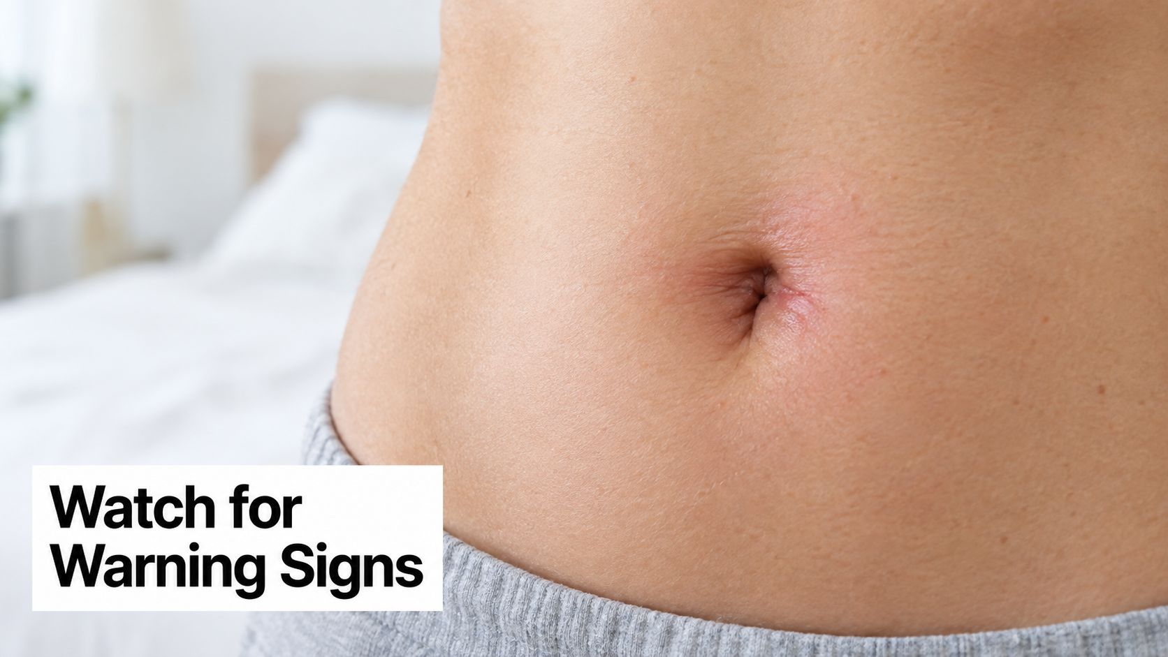 A close-up view of an irritated and red belly button area, highlighting potential signs of infection.