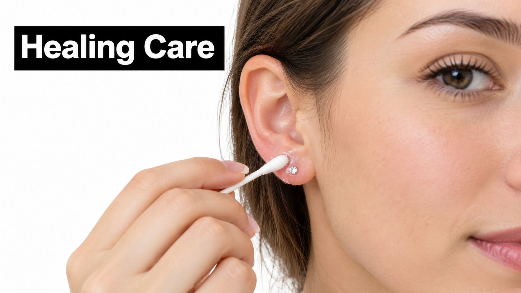 A person applying healing ointment to a newly pierced earlobe with a cotton swab for care.